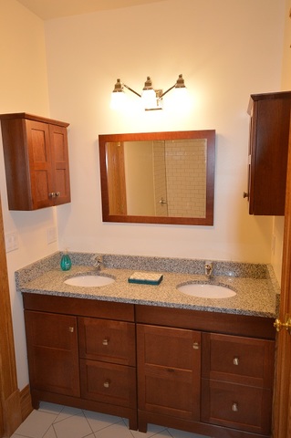 Undisclosed Address Chicago, IL 60657 - Photo 2 of 9 a bathroom with a sink and two mirror
