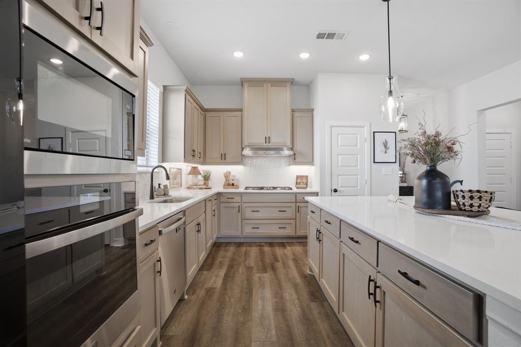 1632 Cotton Road Van Alstyne, TX 75495 - Photo 9 of 40 a kitchen with white cabinets sink and stainless steel appliances