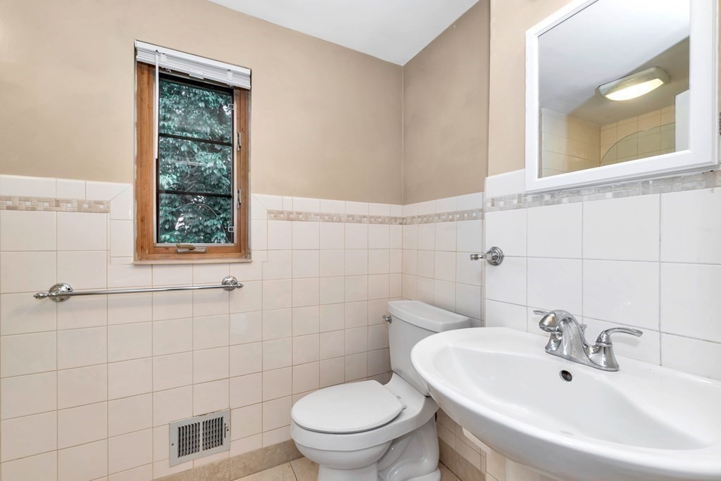 18 Pierce Road, Unit 18 Watertown, MA 02472 - Photo 16 of 38 a bathroom with a toilet a sink and mirror