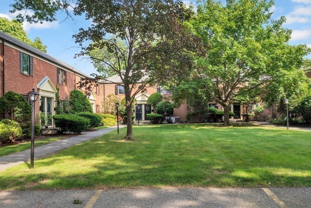 18 Pierce Road, Unit 18 Watertown, MA 02472 - Photo 20 of 38 a house with huge green field in front of it