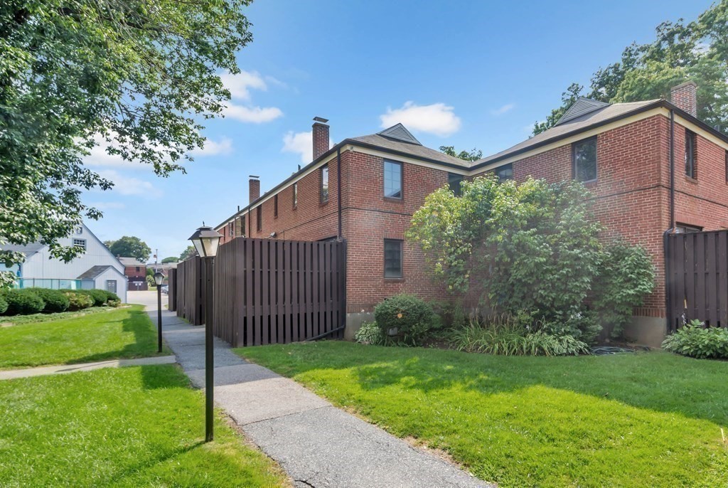 18 Pierce Road, Unit 18 Watertown, MA 02472 - Photo 22 of 38 a view of a small house with a small yard and a large tree