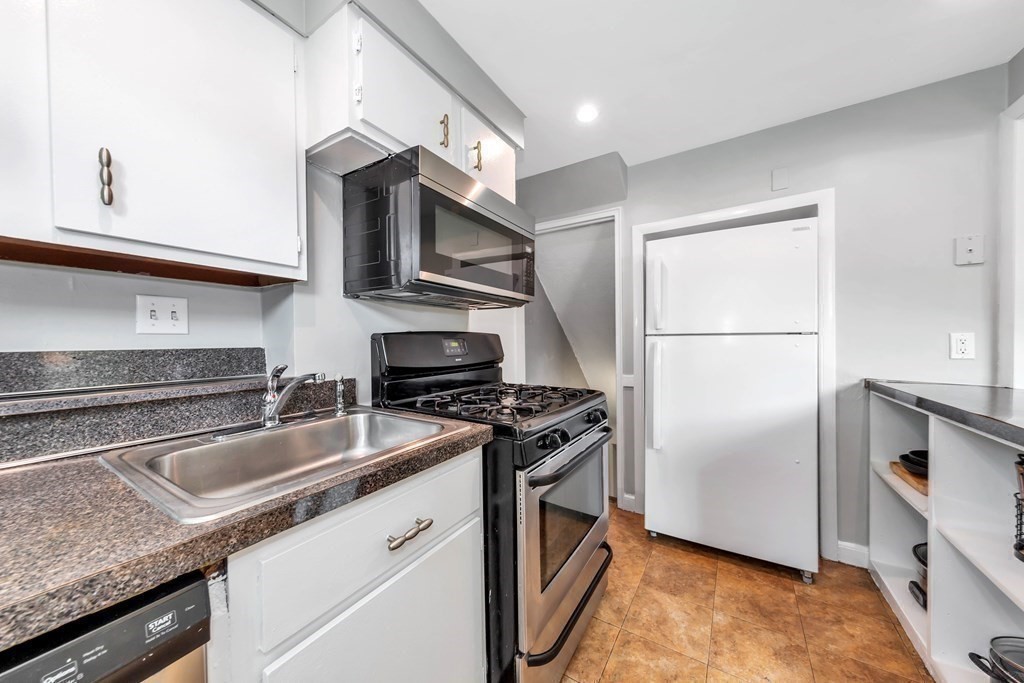 18 Pierce Road, Unit 18 Watertown, MA 02472 - Photo 30 of 38 a kitchen with stainless steel appliances granite countertop a sink stove and refrigerator