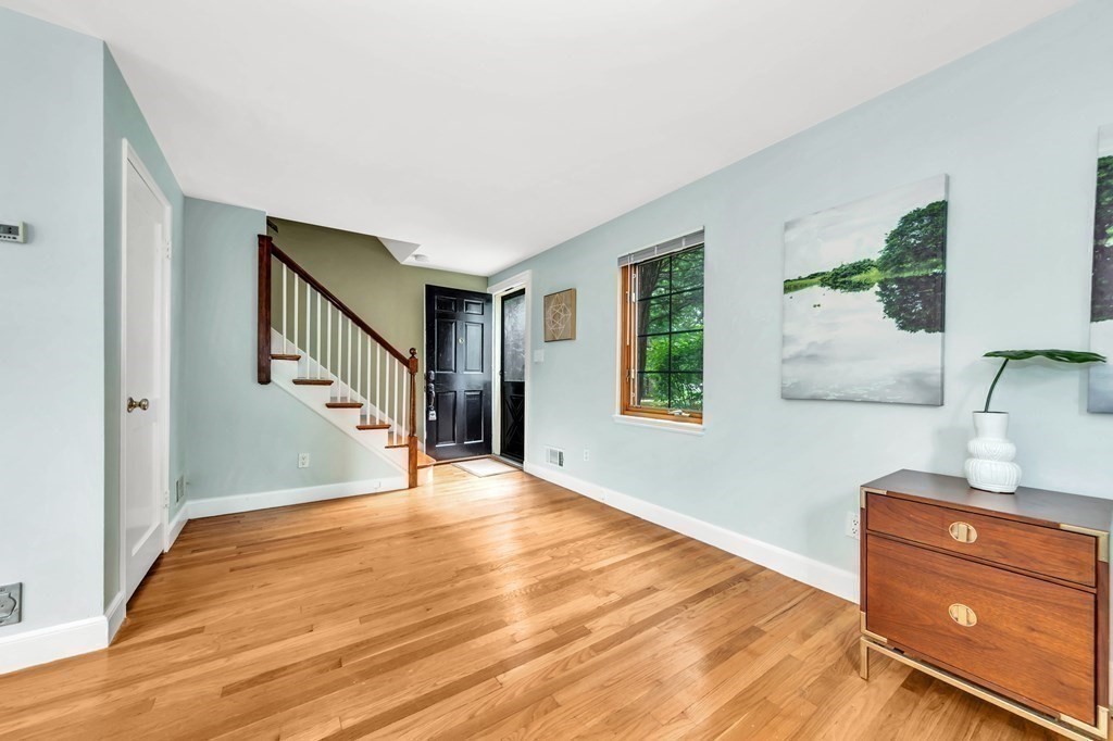 18 Pierce Road, Unit 18 Watertown, MA 02472 - Photo 31 of 38 a view of a hallway with windows and wooden floor