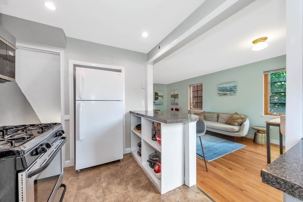 18 Pierce Road, Unit 18 Watertown, MA 02472 - Photo 32 of 38 a living room with furniture and a stove