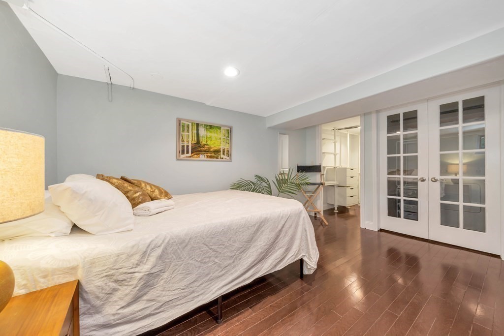 18 Pierce Road, Unit 18 Watertown, MA 02472 - Photo 34 of 38 a bedroom with a bed and wooden floor