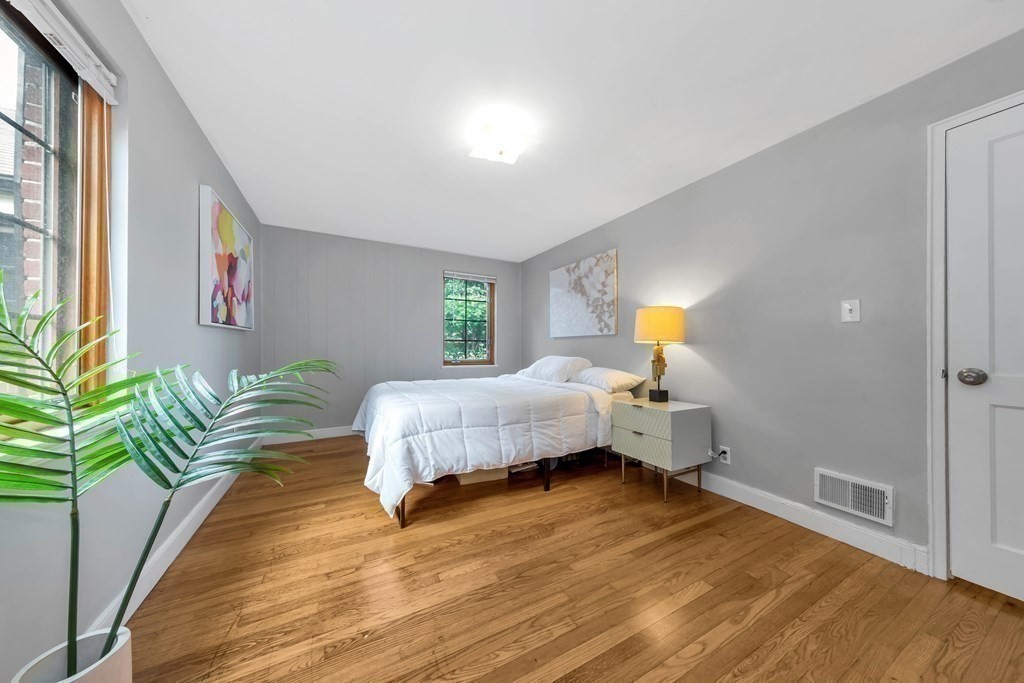 18 Pierce Road, Unit 18 Watertown, MA 02472 - Photo 6 of 38 a bedroom with a bed and wooden floor