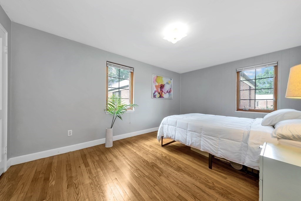 18 Pierce Road, Unit 18 Watertown, MA 02472 - Photo 9 of 38 a bed sitting in a bedroom next to a window