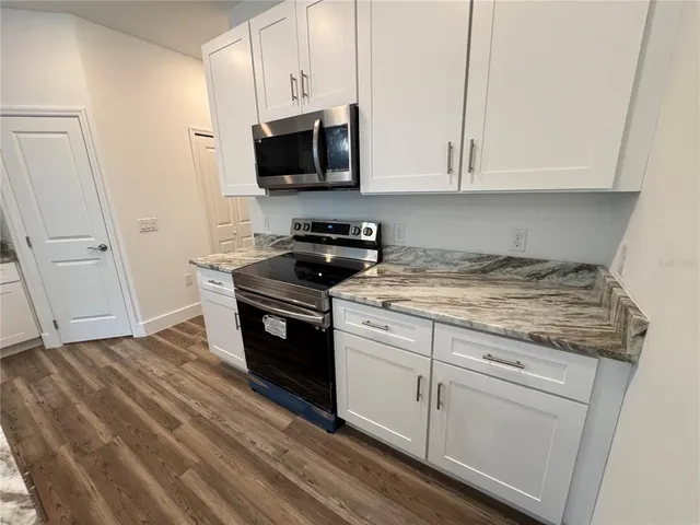 a kitchen that has a sink and a stove top oven