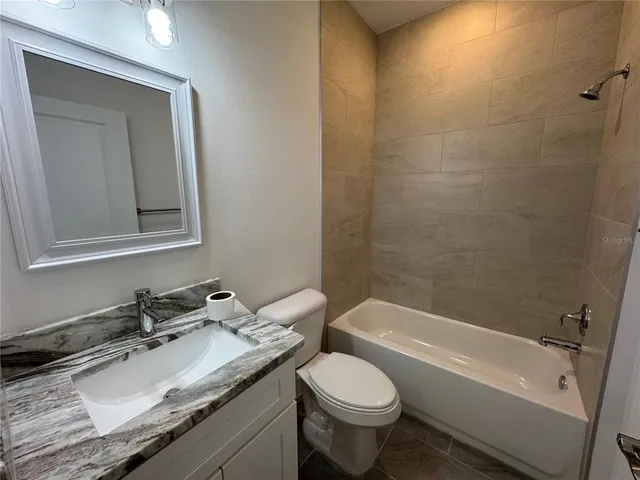a view of kitchen with sink and refrigerator