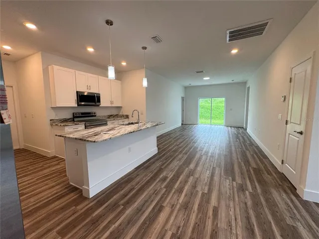 a kitchen with a sink stove and refrigerator
