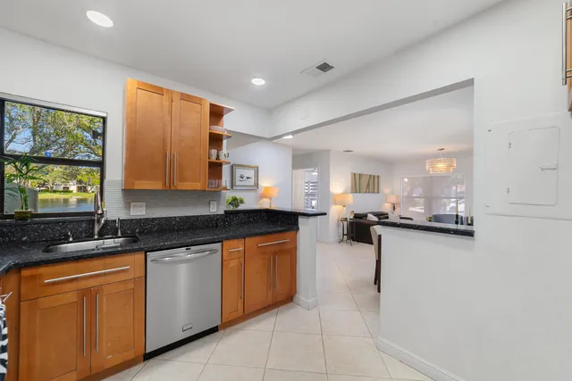 a kitchen with granite countertop a sink and cabinets