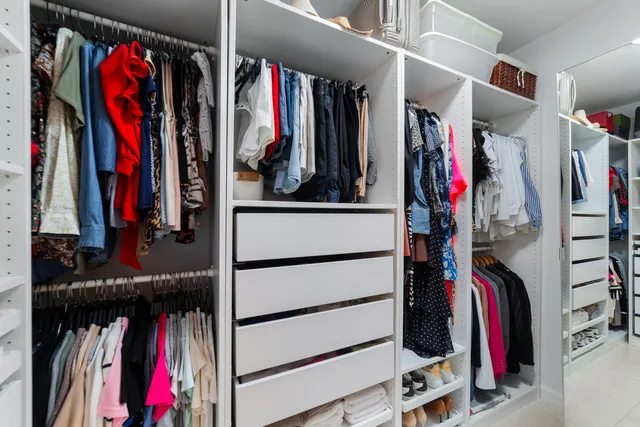 a view of walk in closet with clothes