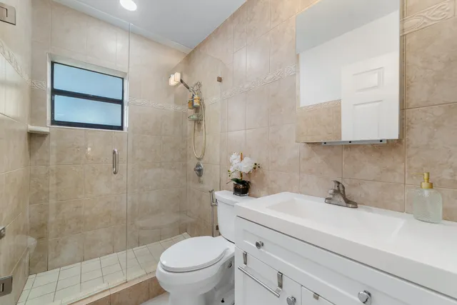 a bathroom with a sink toilet and shower