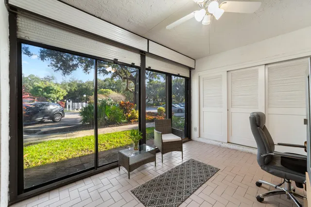 a view of a workspace with furniture and a window