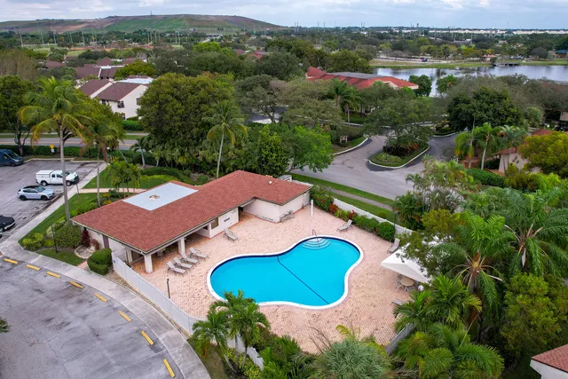 an aerial view of residential houses with outdoor space and parking