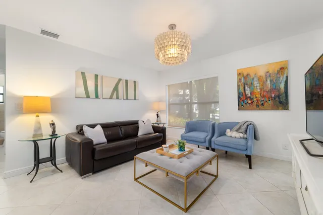 a living room with furniture and a lamp