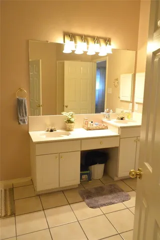 a bathroom with a sink vanity and mirror