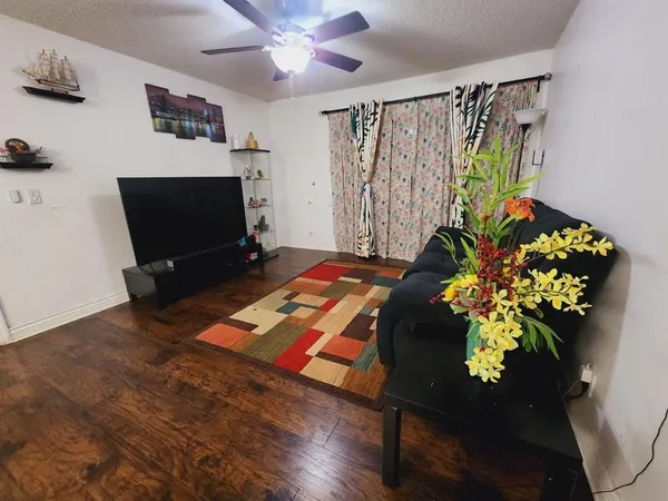 a living room with furniture and a potted plant