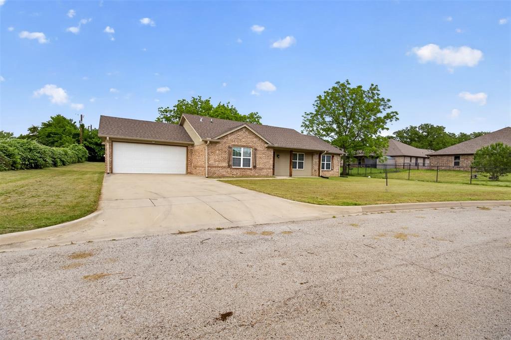 505 East 5th Street Springtown, TX 76082 - Photo 39 of 39 a house with yard in front of it