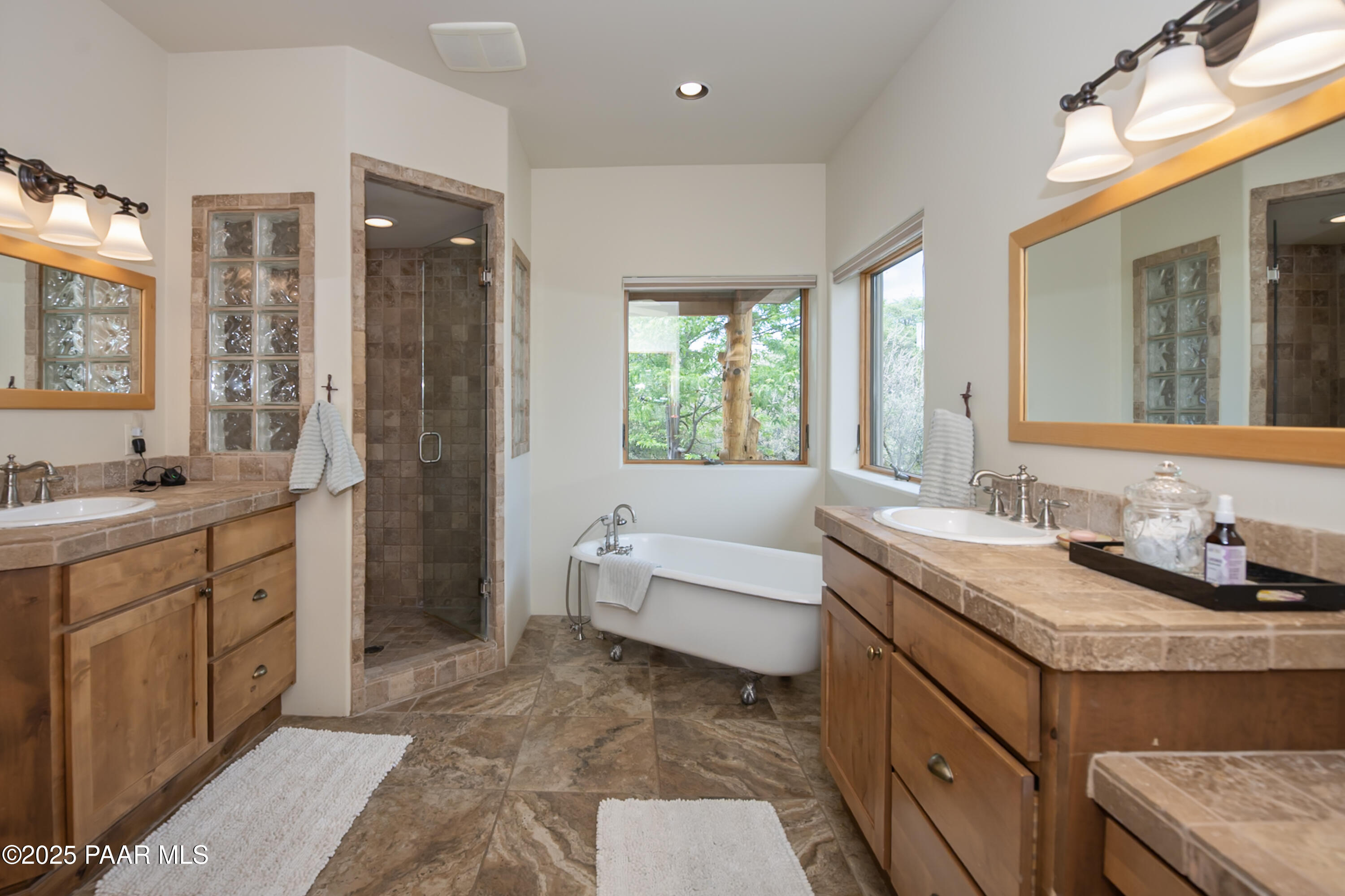 770 Grisby Road Skull Valley, AZ 86338 - Photo 21 of 58 a bathroom with a granite countertop double vanity sink large mirror and a bathtub