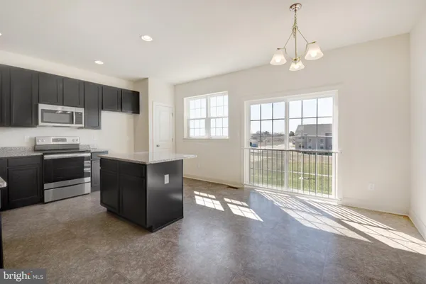 a view of a kitchen with stove cabinets and a living room