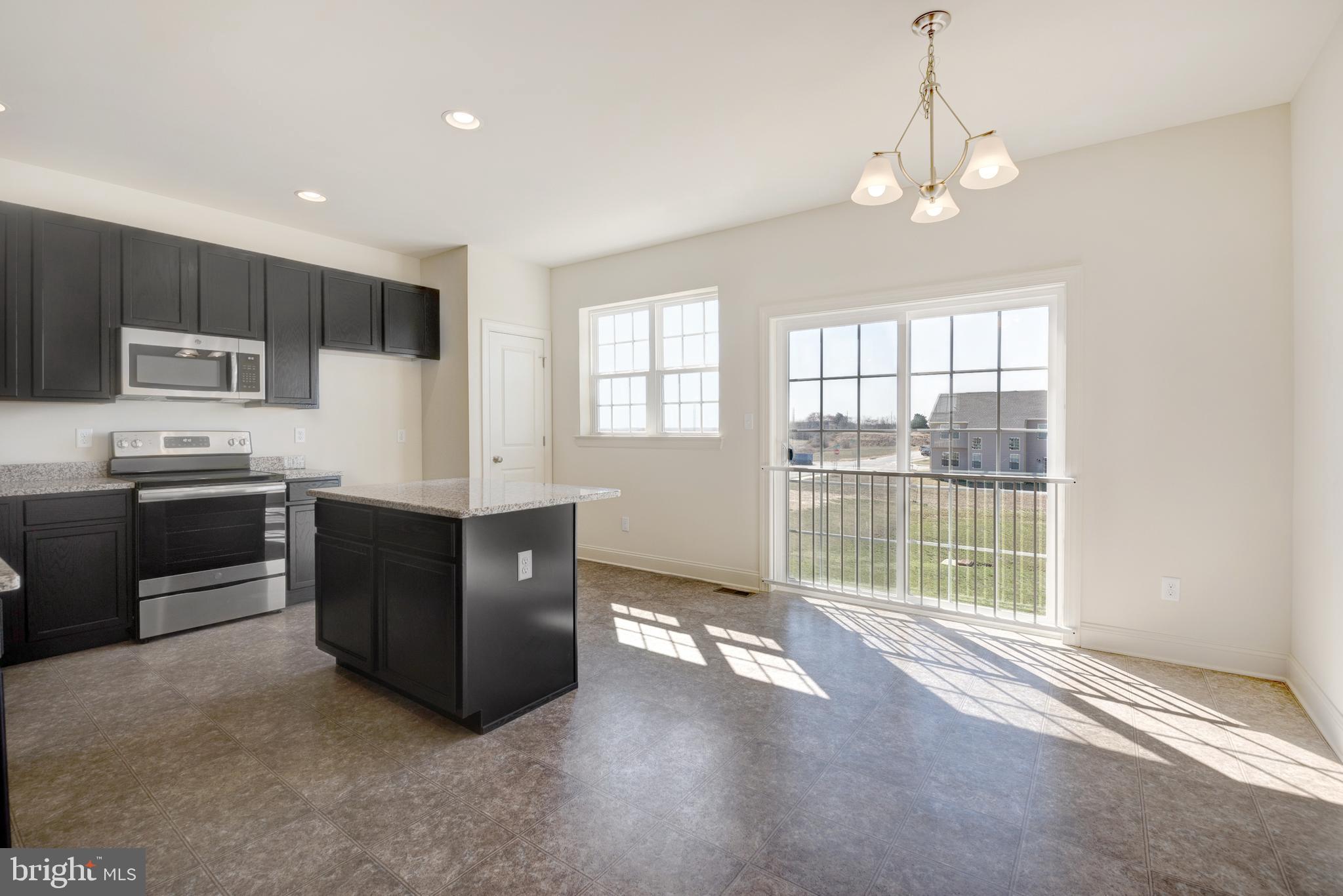 460 Rederick Lane Middletown, DE 19709 - Photo 3 of 12 a view of a kitchen with stove cabinets and a living room