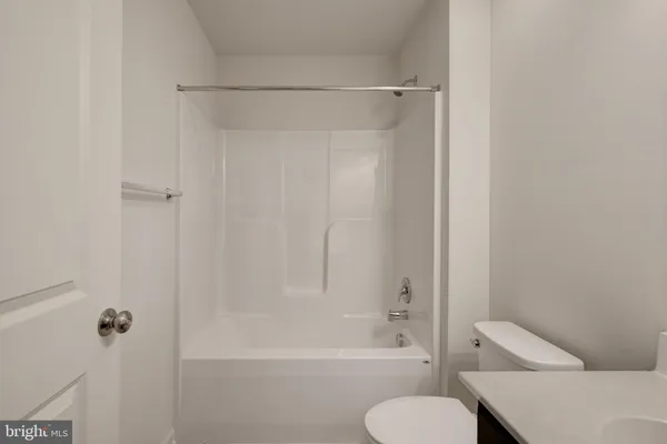 a bathroom with a toilet and a bathtub
