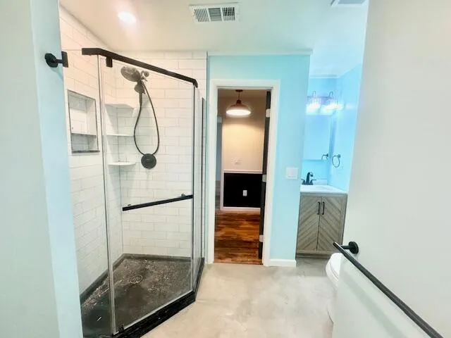 a bathroom with a shower and mirror