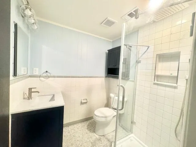 a bathroom with a sink toilet a mirror and shower