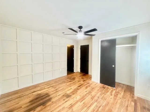 a big room with closet and ceiling fan