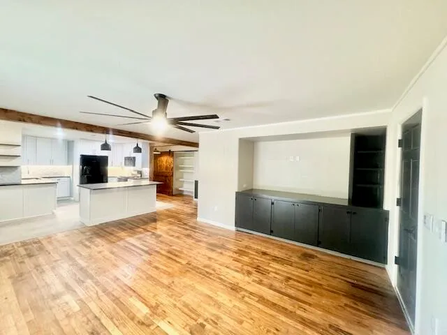 a view of a kitchen with a sink and a refrigerator