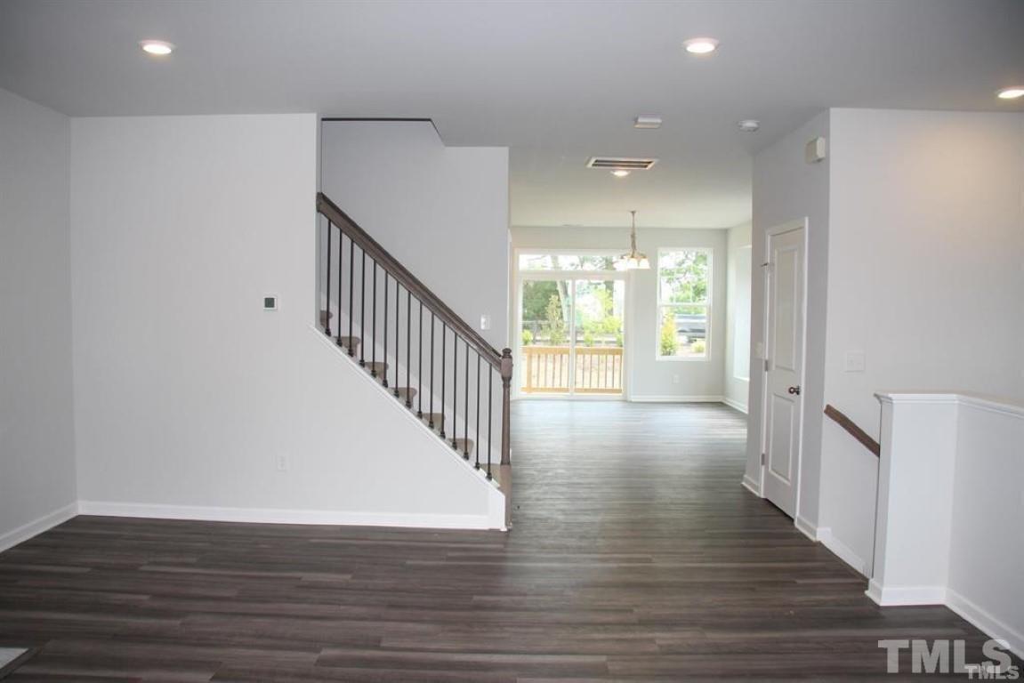 2919 Sunflower Road Apex, NC 27502 - Photo 17 of 34 a view of a hallway with wooden floor