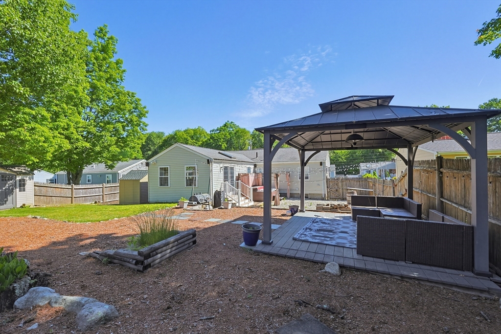 118 Spruce Road Norwood, MA 02062 - Photo 35 of 39 a view of patio with a table and chairs under an umbrella