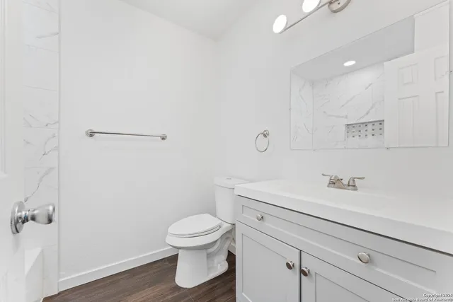 a bathroom with a sink a toilet and a mirror