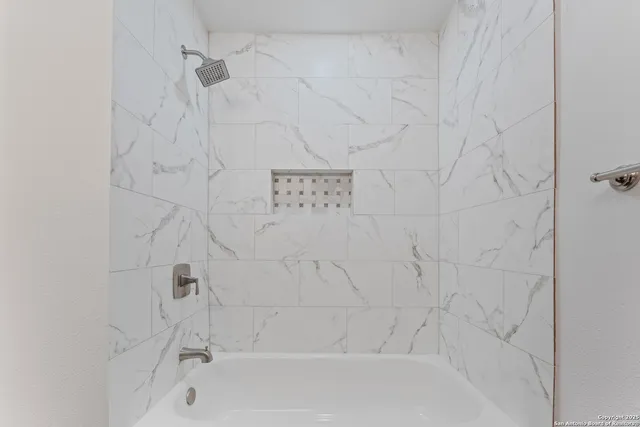 a bathroom with a shower and a bath tub