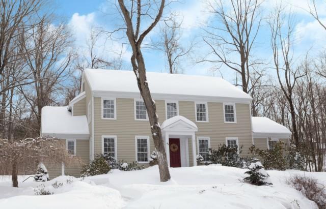 46 Pocahontas Road Redding, CT 06896 - Photo 1 of 1 a front view of a house with a yard covered in snow