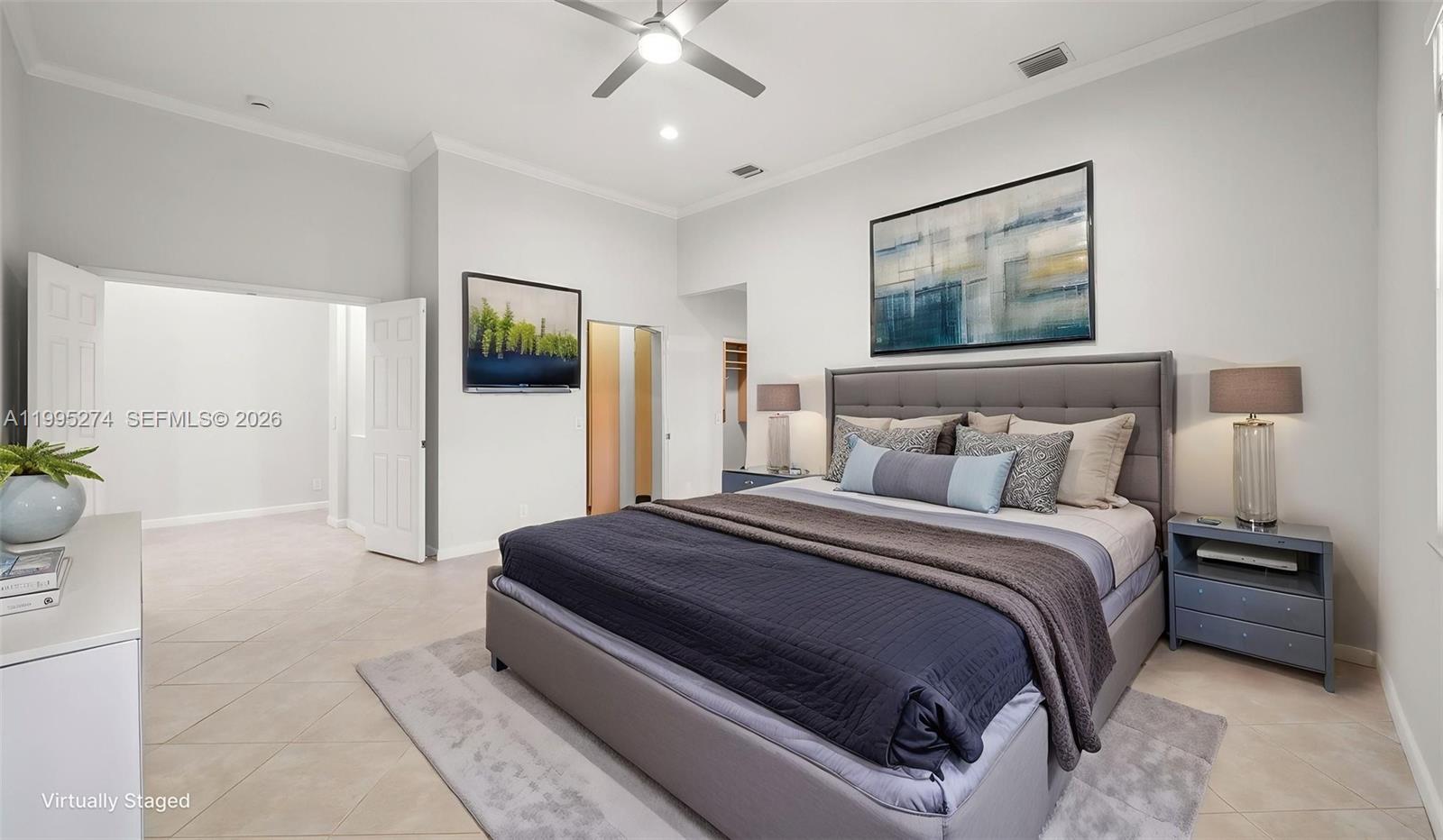1907 Timberline Road Weston, FL 33327 - Photo 11 of 18 a spacious bedroom with a bed and a painting