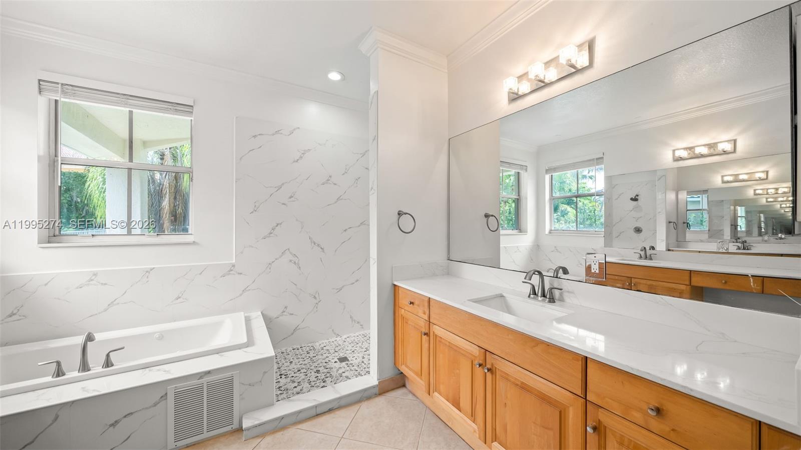 1907 Timberline Road Weston, FL 33327 - Photo 12 of 18 a bathroom with a sink and a bathtub