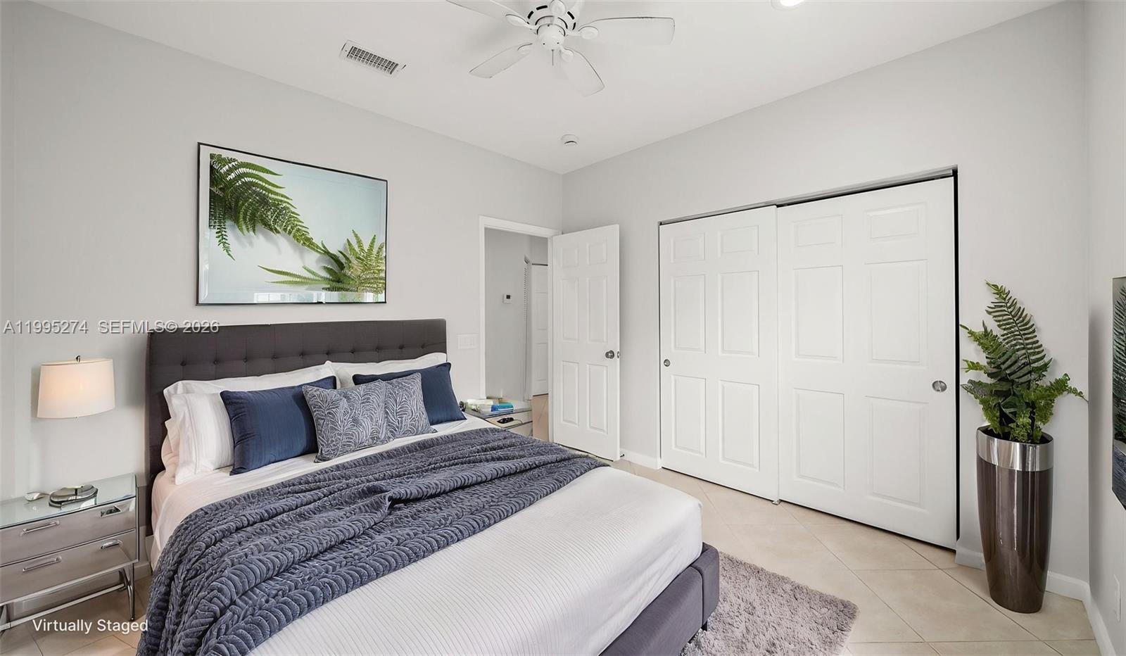 1907 Timberline Road Weston, FL 33327 - Photo 14 of 18 a bedroom with a bed and a potted plant