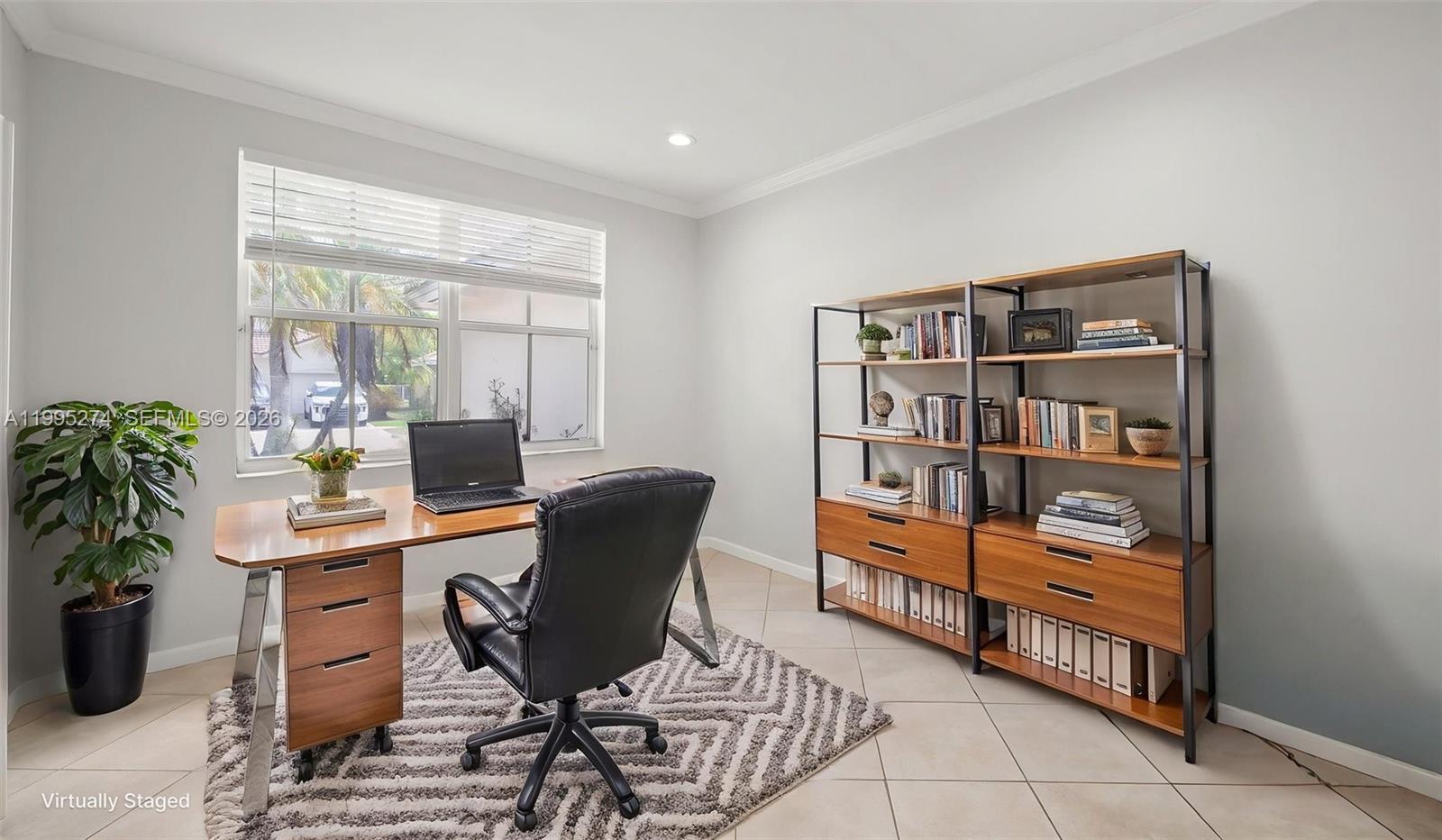 1907 Timberline Road Weston, FL 33327 - Photo 3 of 18 a workspace with furniture and book shelf