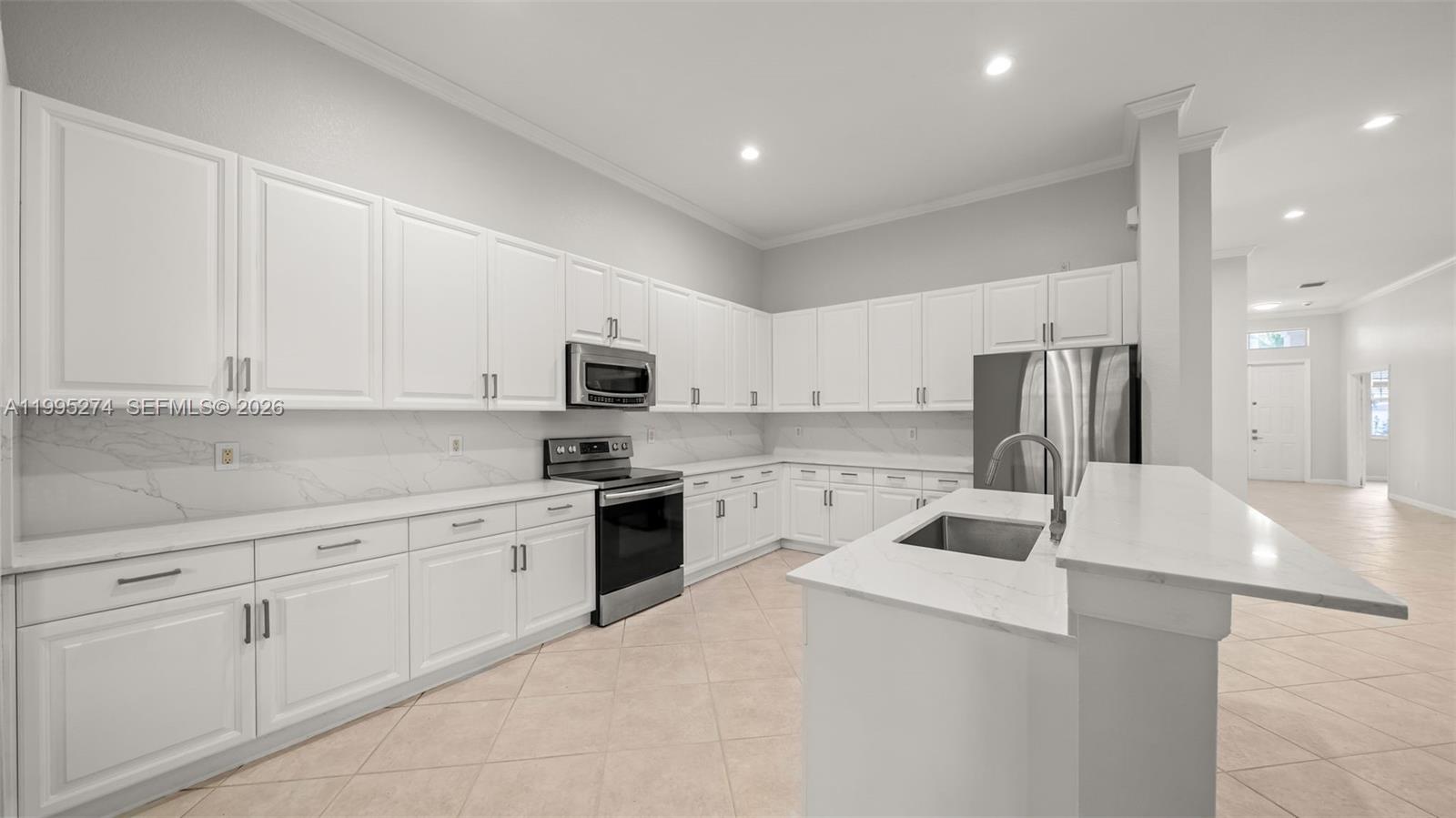 1907 Timberline Road Weston, FL 33327 - Photo 6 of 18 a large white kitchen with cabinets