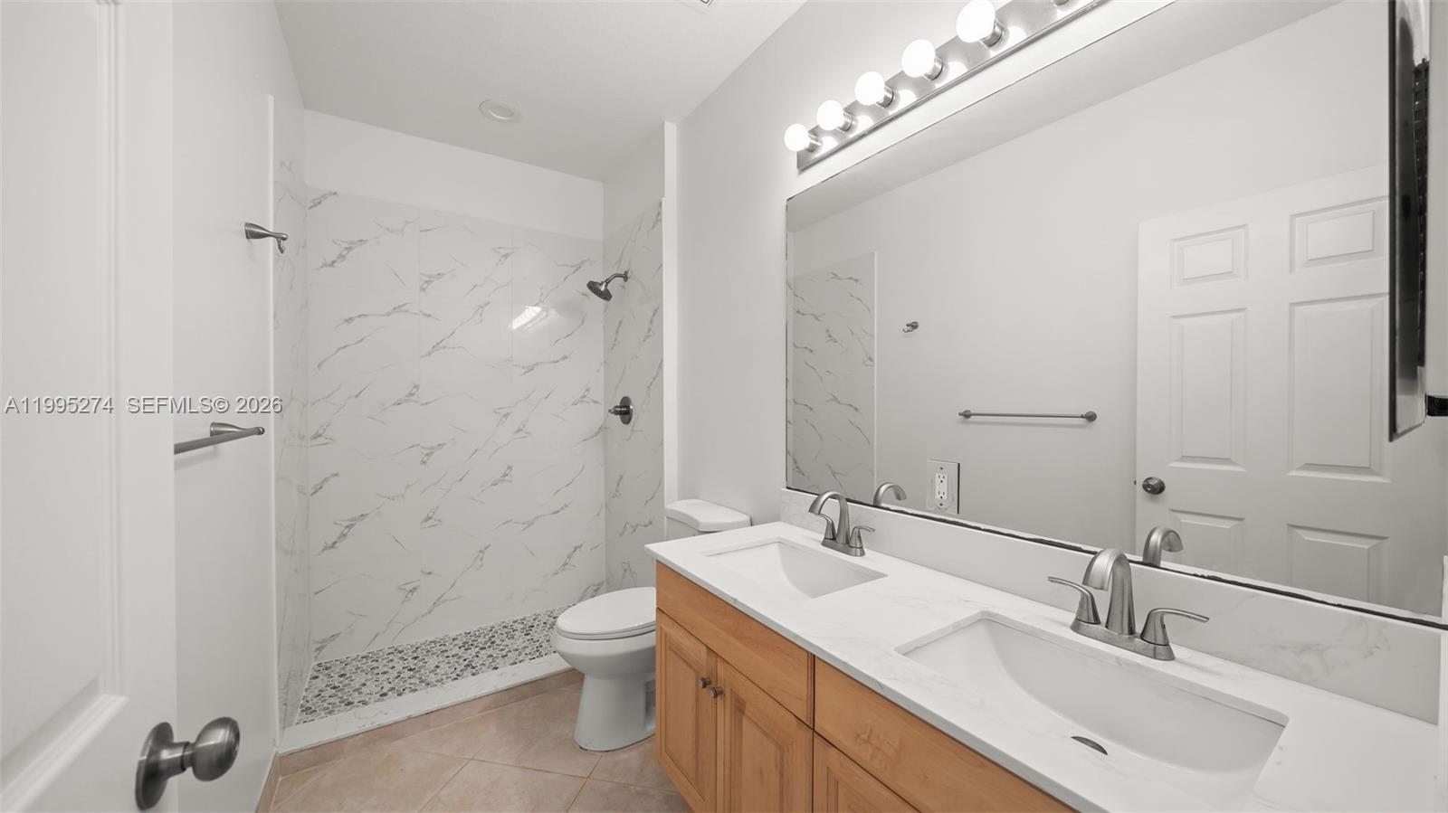 1907 Timberline Road Weston, FL 33327 - Photo 9 of 18 a bathroom with a sink toilet double vanity and shower