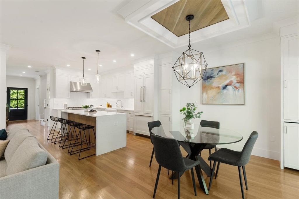 1124 Chestnut Street Newton, MA 02464 - Photo 6 of 41 a view of a dining room with furniture wooden floor and a chandelier