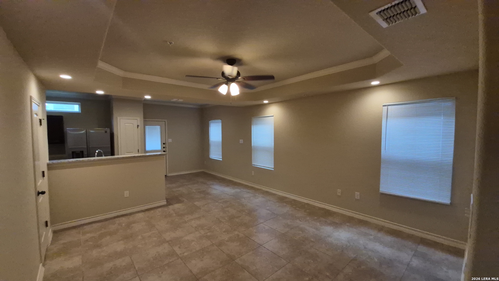 6414 Luglio Lane, Unit 101 San Antonio, TX 78233 - Photo 2 of 23 an empty room with windows and fan