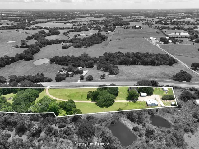an aerial view of a house with a yard