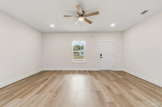 wooden floor in an empty room with a window