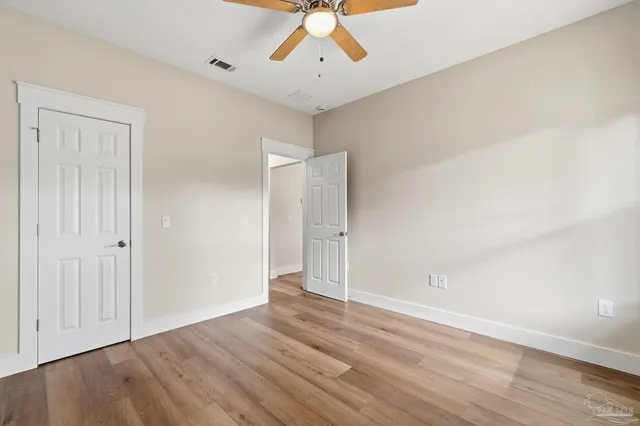 a view of a yard with wooden fence