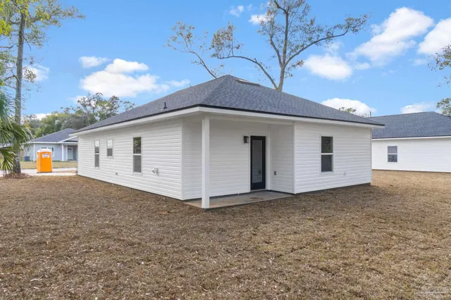 a house that has a tree in front of it