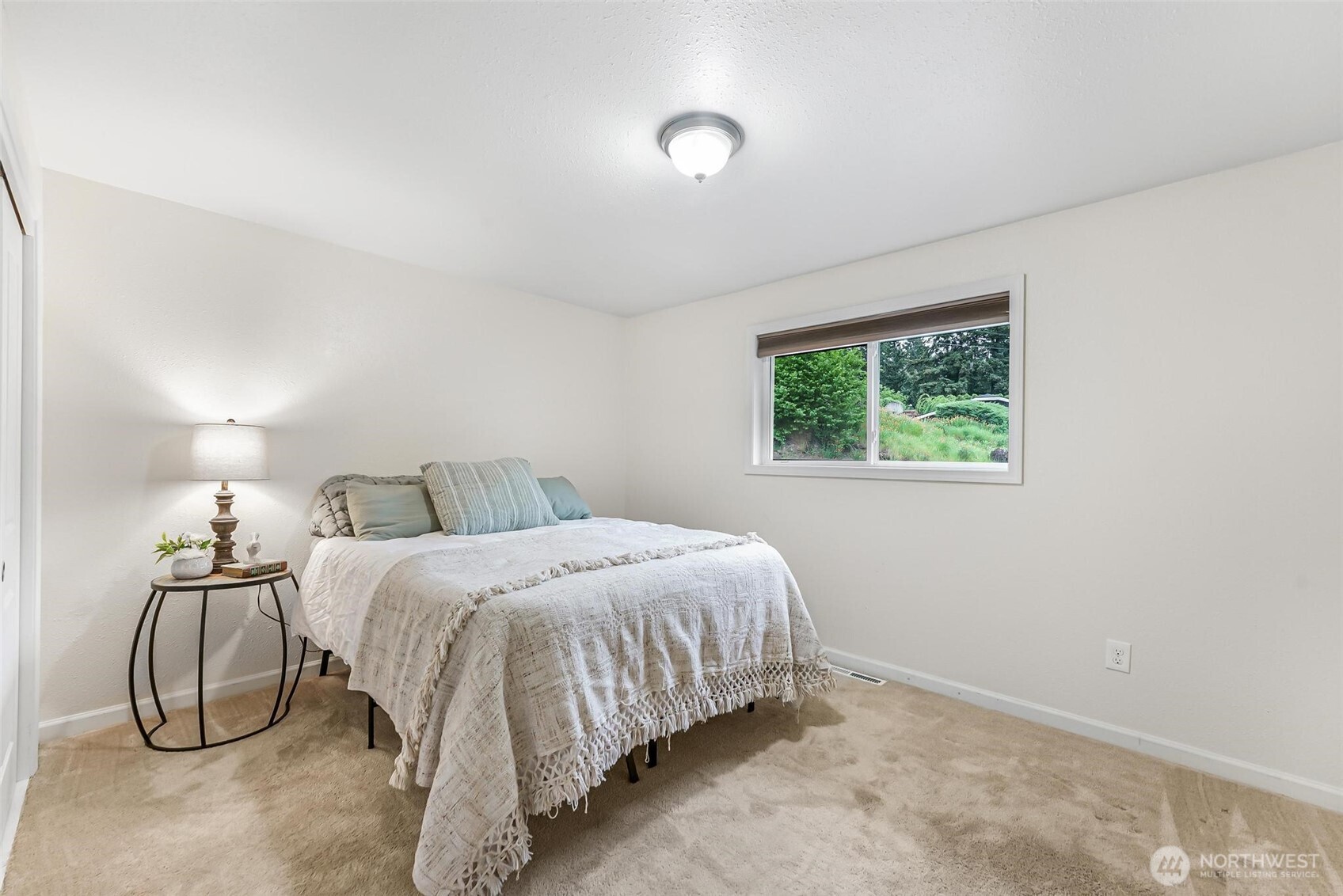 11404 Karshner Road East Edgewood, WA 98372 - Photo 21 of 40 a bedroom with a bed and a window