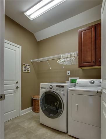 369 Truman Road West Franklin, TN 37064 - Photo 17 of 20 THE LAUNDRY ROOM IS LOCATED JUST OFF THE KITCHEN & GARAGE AND FEATURES LVT TILE FLOORS, CABINETS & A HANGING RACK